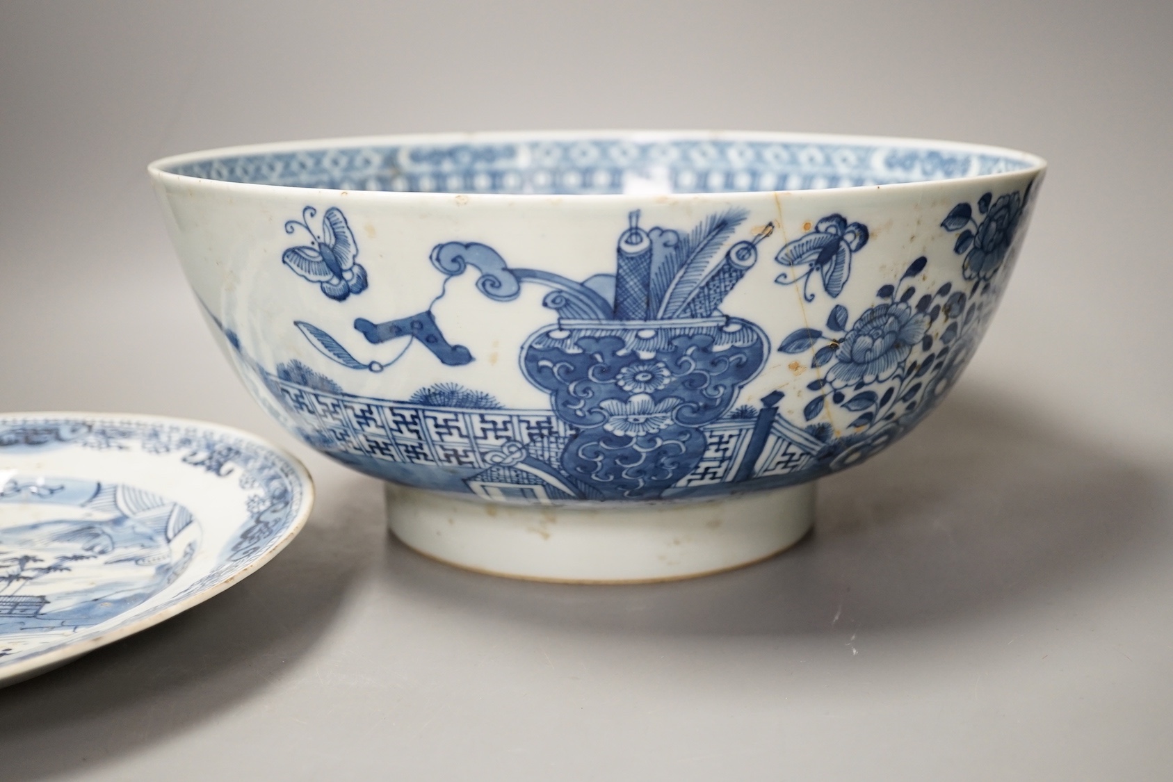 An 18th century Chinese blue and white punch bowl and similar plate. Largest 29cm